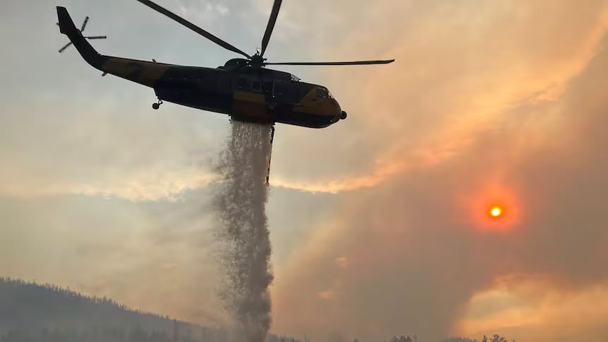 iN PHOTOS: Wildfire smoke creates haunting atmosphere in the Okanagan, Kamloops | iNFOnews.ca An airtanker dumps water on a fire.