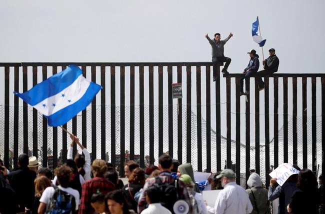 The Latest: Some caravan of asylum seekers waiting at border | iNFOnews.ca