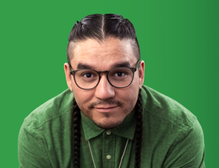 There is a headshot of a man with a green background.