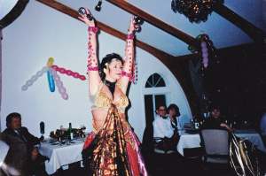 A belly dancer is shown in an old photo.