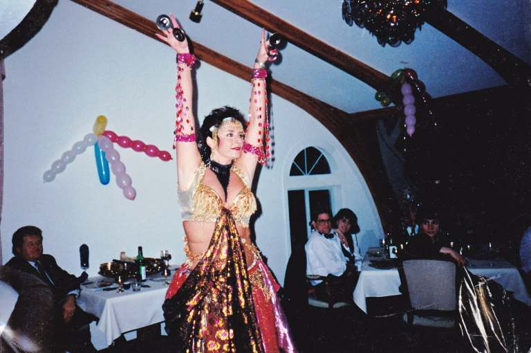 A belly dancer is shown in an old photo.