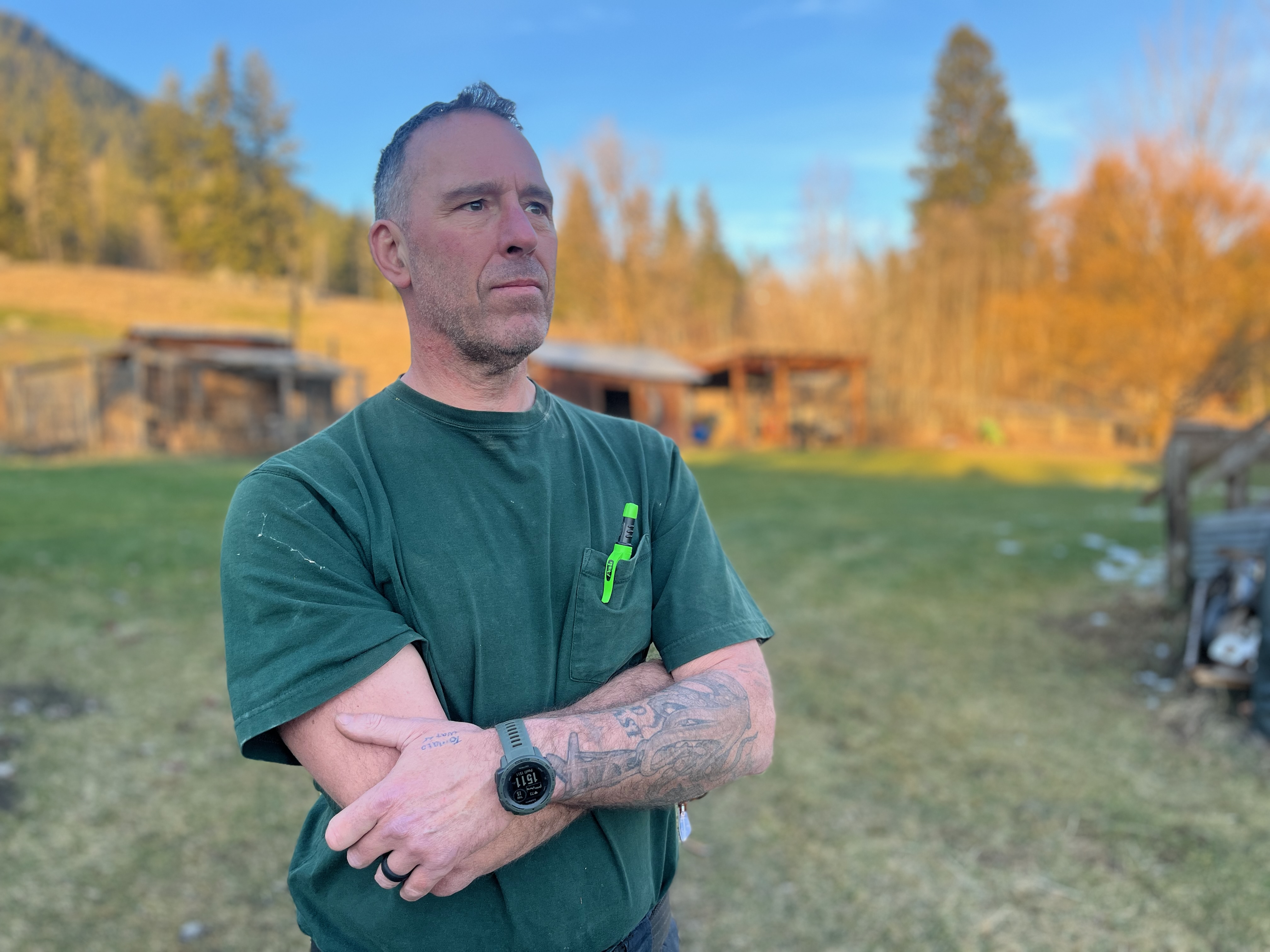 Retired Mountie Dave Goodyear stands in a field.