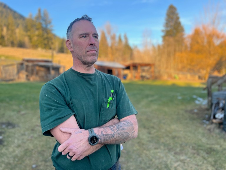 Retired Mountie Dave Goodyear stands in a field.