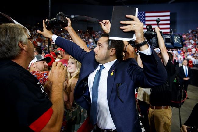 The Latest: Trump volunteer blocks photographer's rally shot | iNFOnews.ca CP465413706