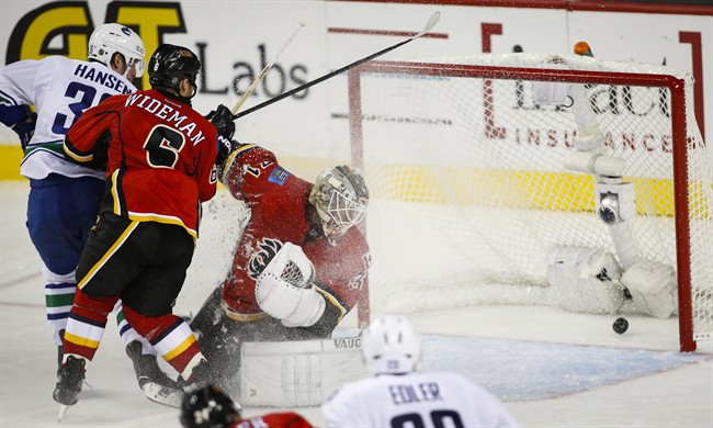 Calgary Flames stumble in home opener, lost to Vancouver Canucks 5-1 | iNFOnews.ca CP34867651