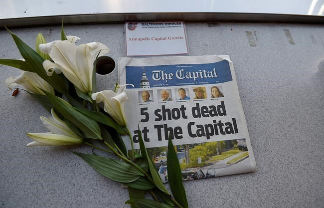 The Latest: Hundreds attend vigil for slain paper staffers | iNFOnews.ca CP454492260