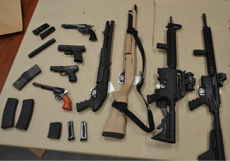 Firearms and ammunition seized by RCMP in Lake Country on display.