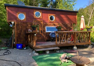 A tiny home with a deck.