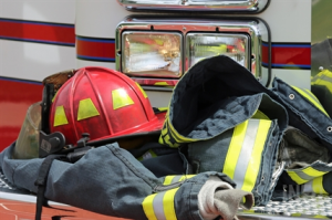 Firefighter gear is piled at the front of a fire truck.