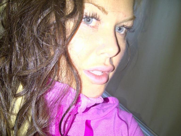 A woman poses for a selfie.