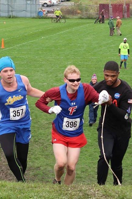 Runner praised for helping legally blind competitor who fell | iNFOnews.ca