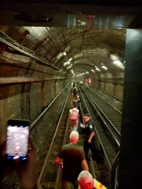 Commuters walk through tunnel when Boston subway loses power | iNFOnews.ca