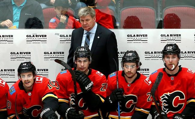 Flames coach Bill Peters hit in face by puck | iNFOnews.ca