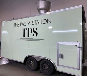 A light green trailer with words 'The Pasta Station TPS' on the side.