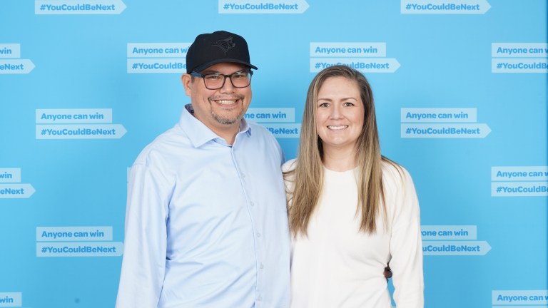 A man and woman pose for a photo.