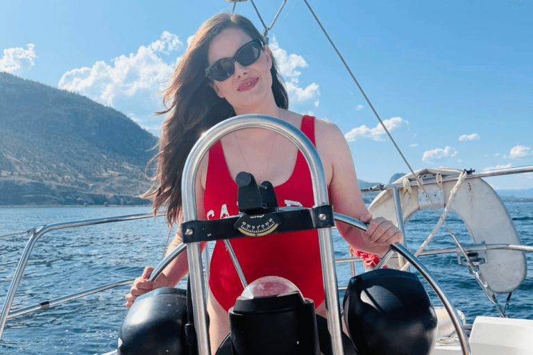 Amelia Boultbee driving a boat on the lake.