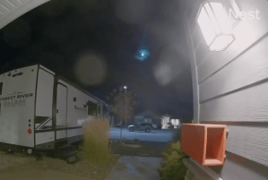 A meteor is seen in the night sky.
