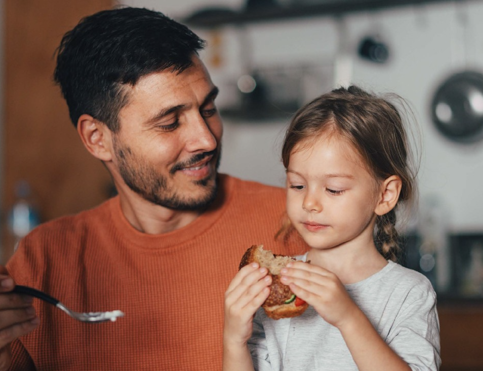 A man and a young girl sharing a meal.