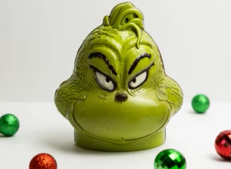 A Grinch head made of chocolate on a white background.