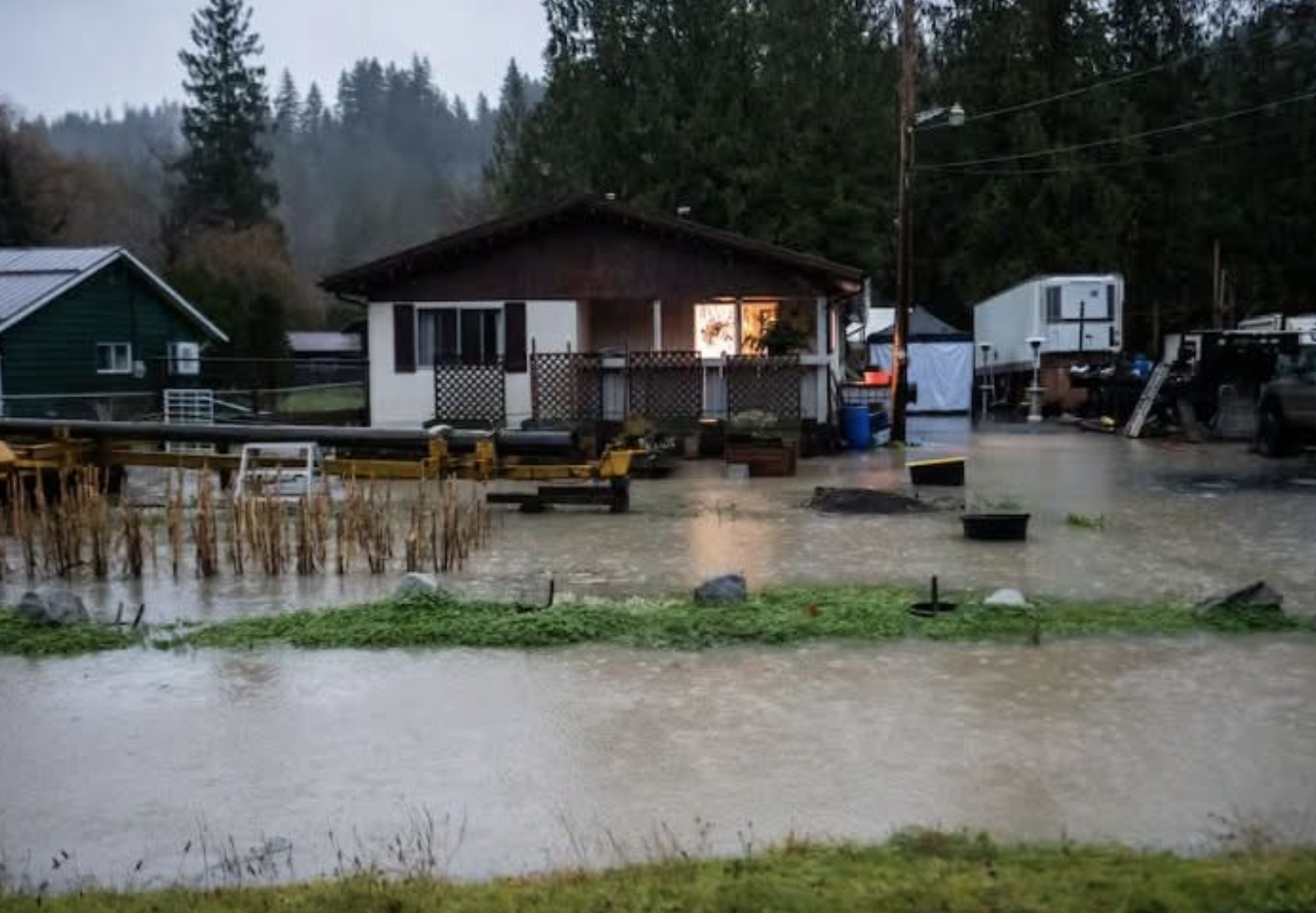 High water around some houses on a stormy day.