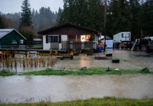 High water around some houses on a stormy day.