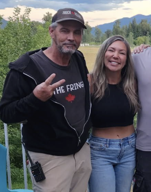 Timothy John Regan stands next to Katie Pasitney and other protesters at the Universal Ostrich Farm.