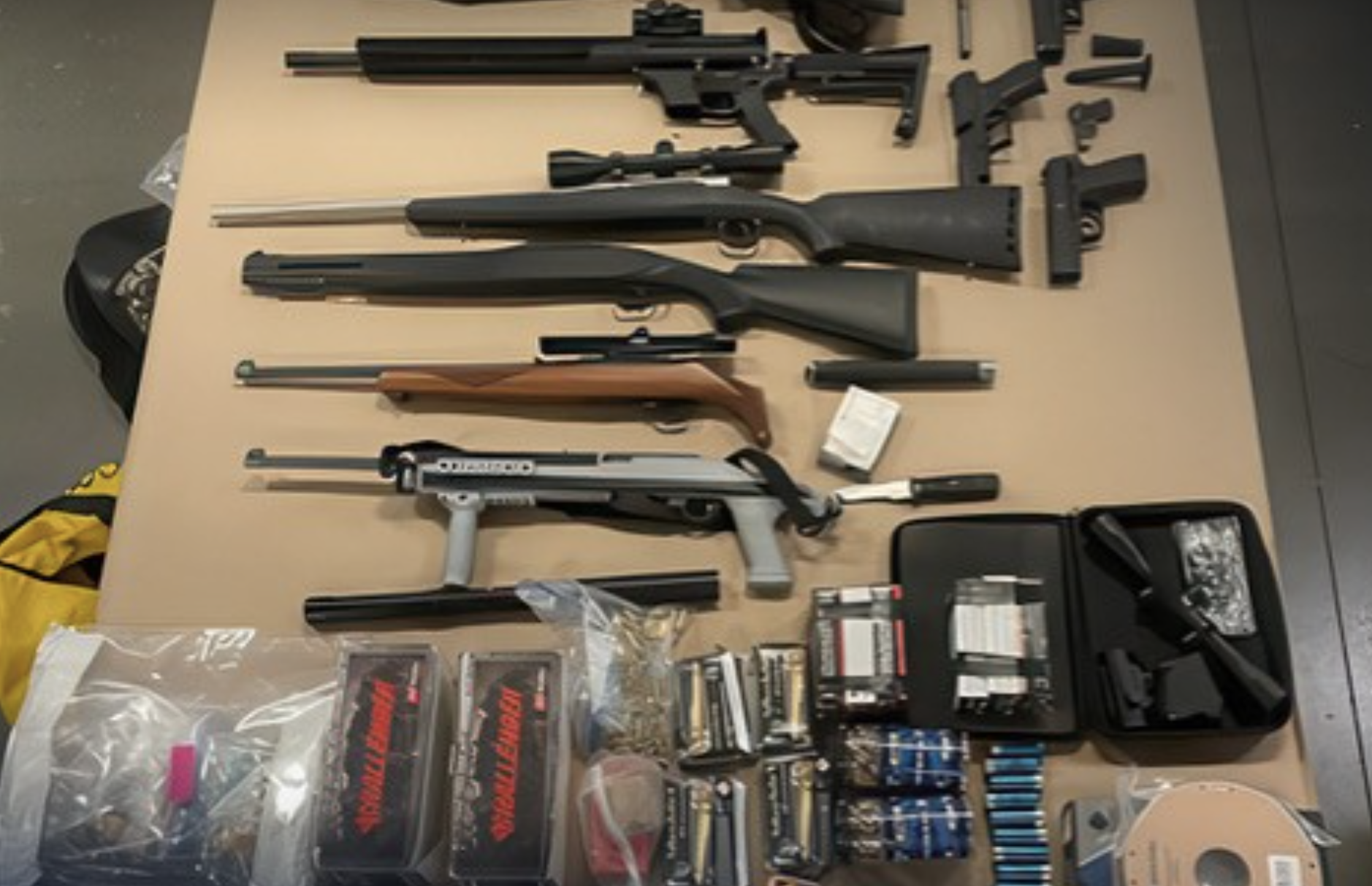 Guns and bullets laid out on a table.