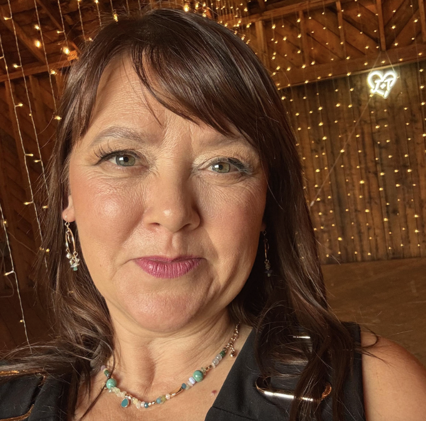 A woman smiles for a photo.