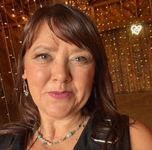 A woman smiles for a photo.