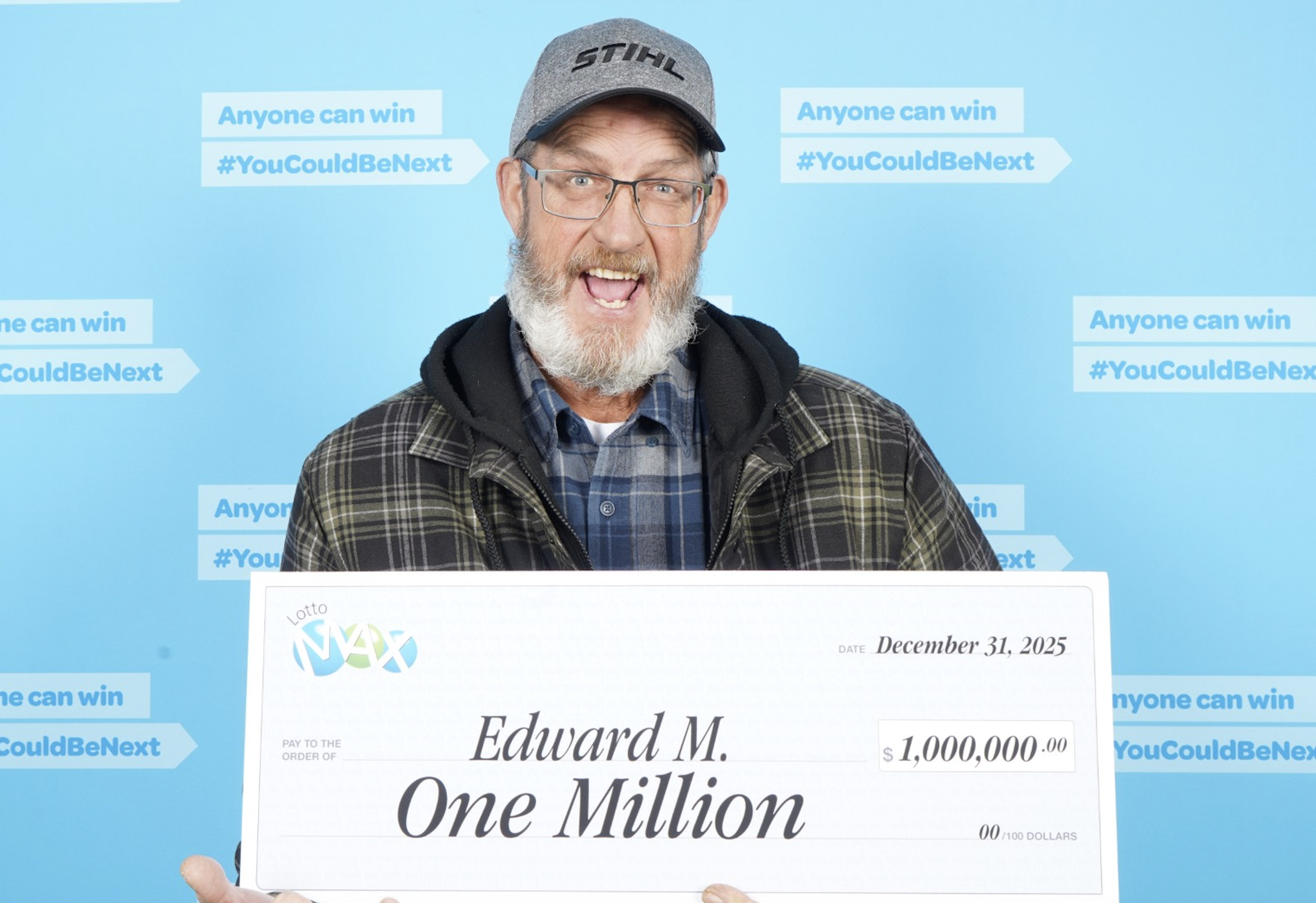 An excited man holding a big check.