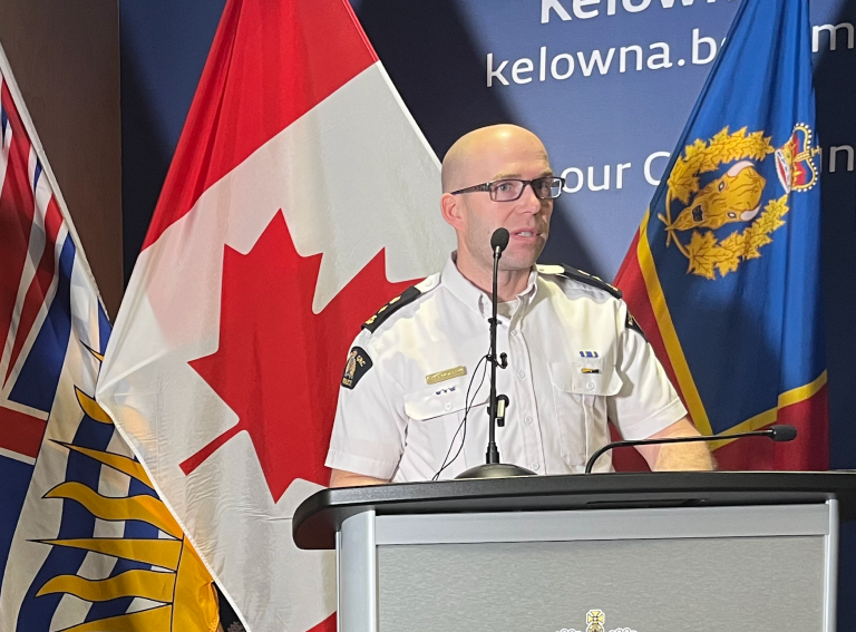 A man in an RCMP uniform at a podium.