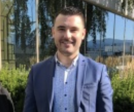 Wearing a blue suit jacket Marc-Antoine Ladeiro stands for a photo.