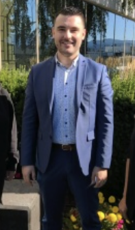 Wearing a blue suit jacket Marc-Antoine Ladeiro stands for a photo.