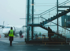 People on the tarmac at an airport.