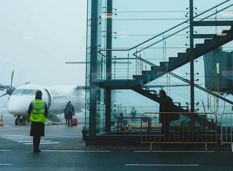 People on the tarmac at an airport.