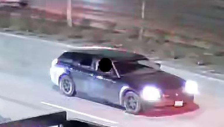 A car driving on a road at night.