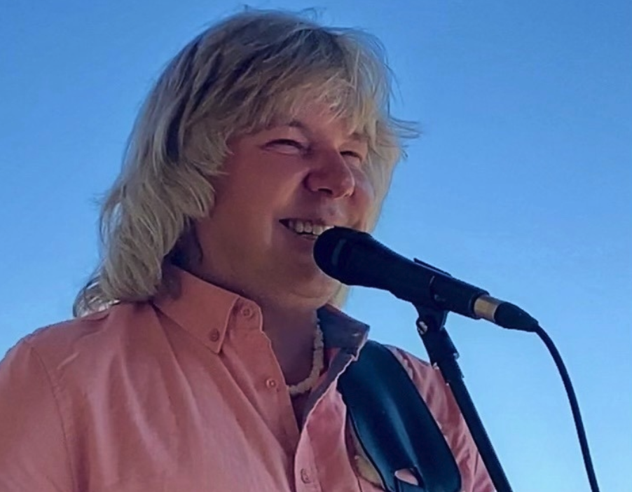 Marvyn Goerge Machura sings in to a microphone