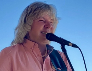 Marvyn Goerge Machura sings in to a microphone