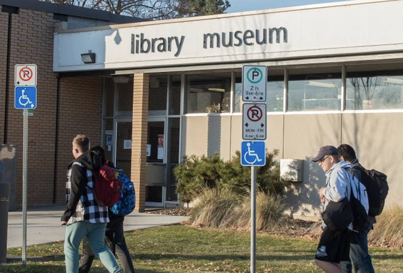 People walking past a library.