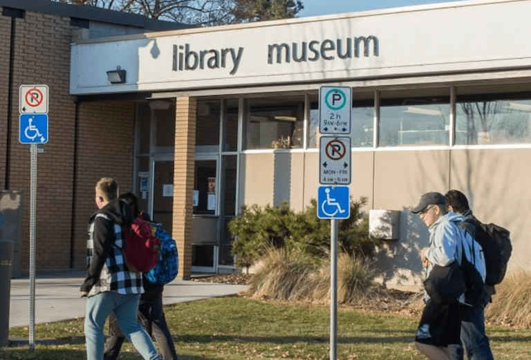 People walking past a library.