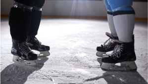 Two hockey players face each other on the ice.