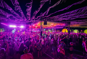 People dance under disco lights a music festival