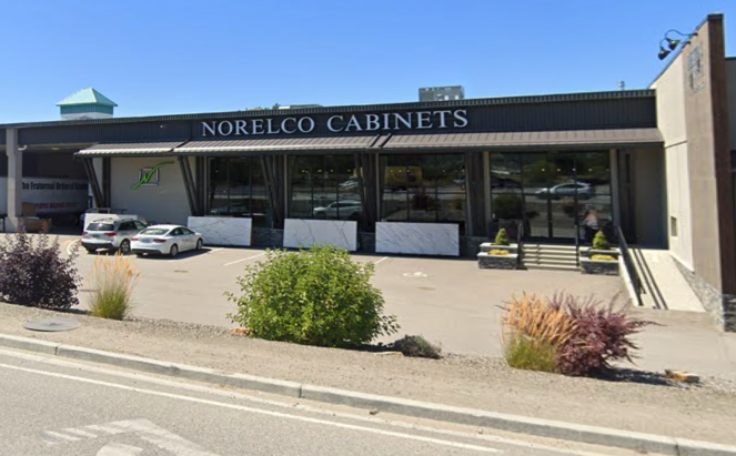 Cars parkd outside of the Norelco Cabinets building.