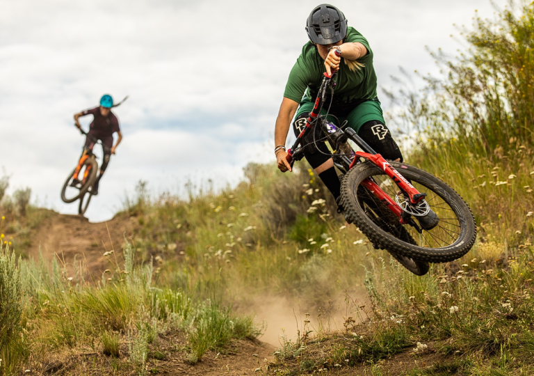Two mountain bikers going downhill.