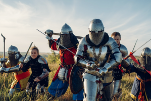 People dressed in period costumes including knights in armour.