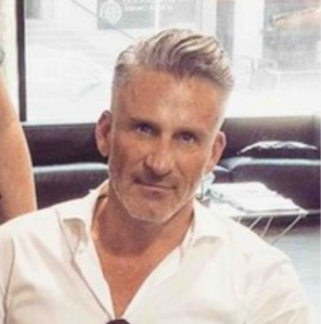 A man wearing a white shirt.