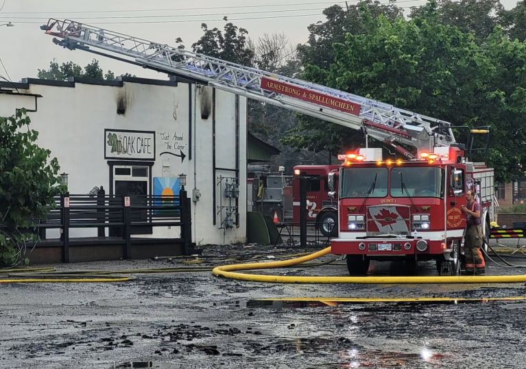 A fire truck with a ladder extended following a business fire.