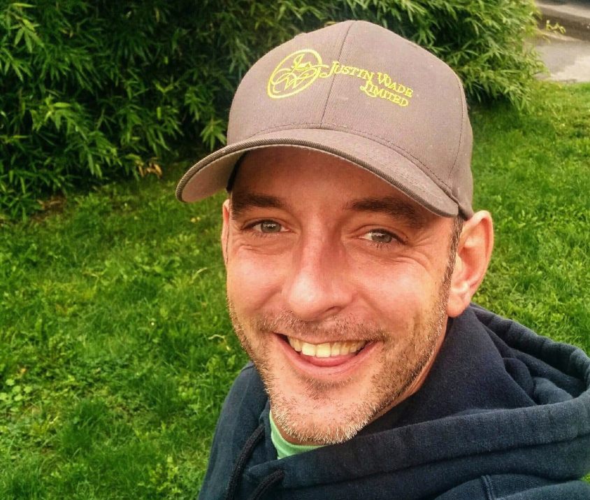 Bryan Miles wear a baseball cap.