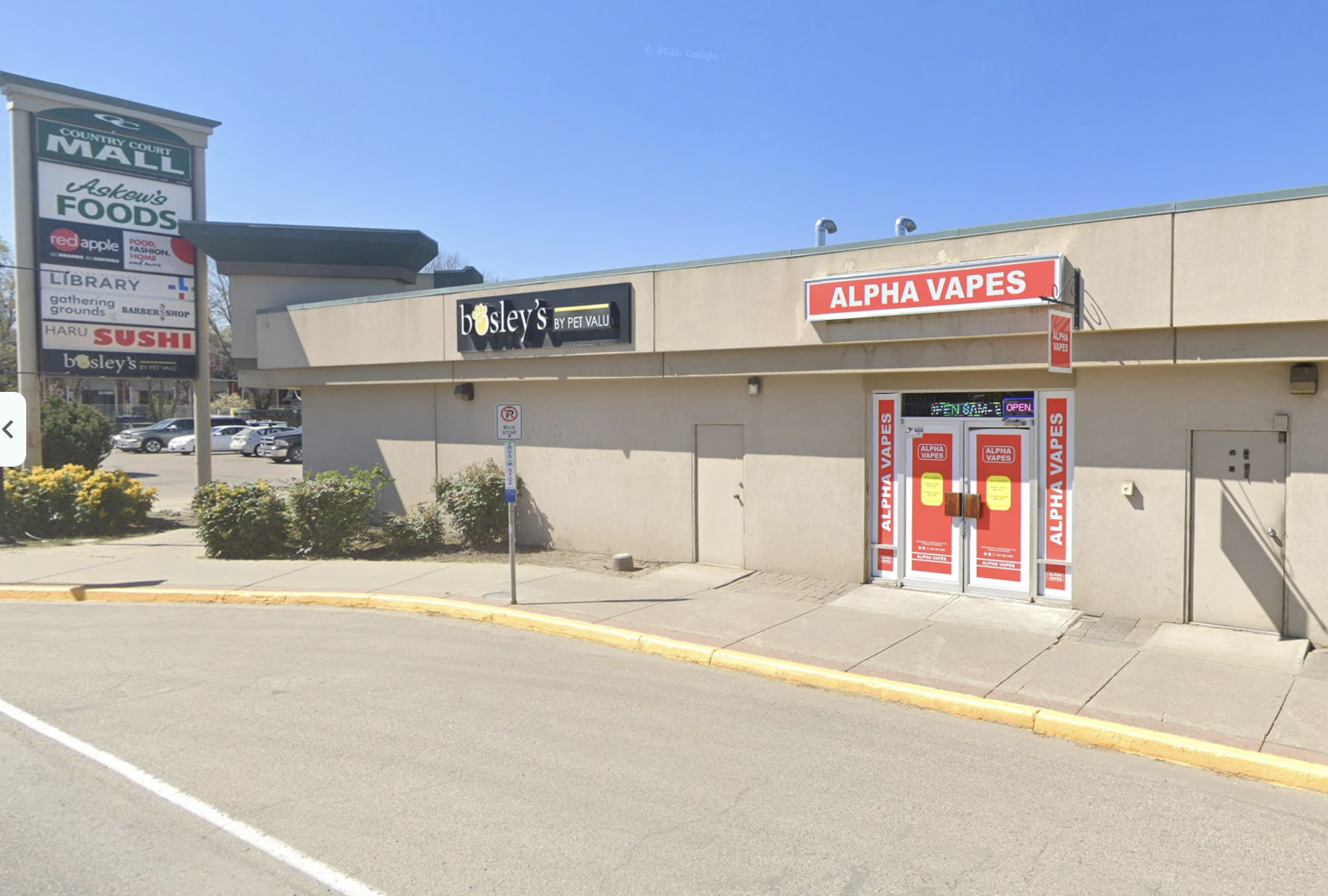 A strip mall with a vape shop.