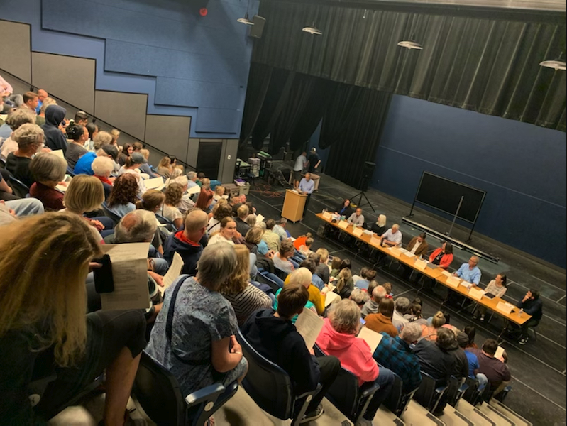 An audience attends an all-candidates debate.